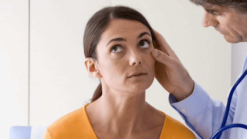doctor examining woman's eye